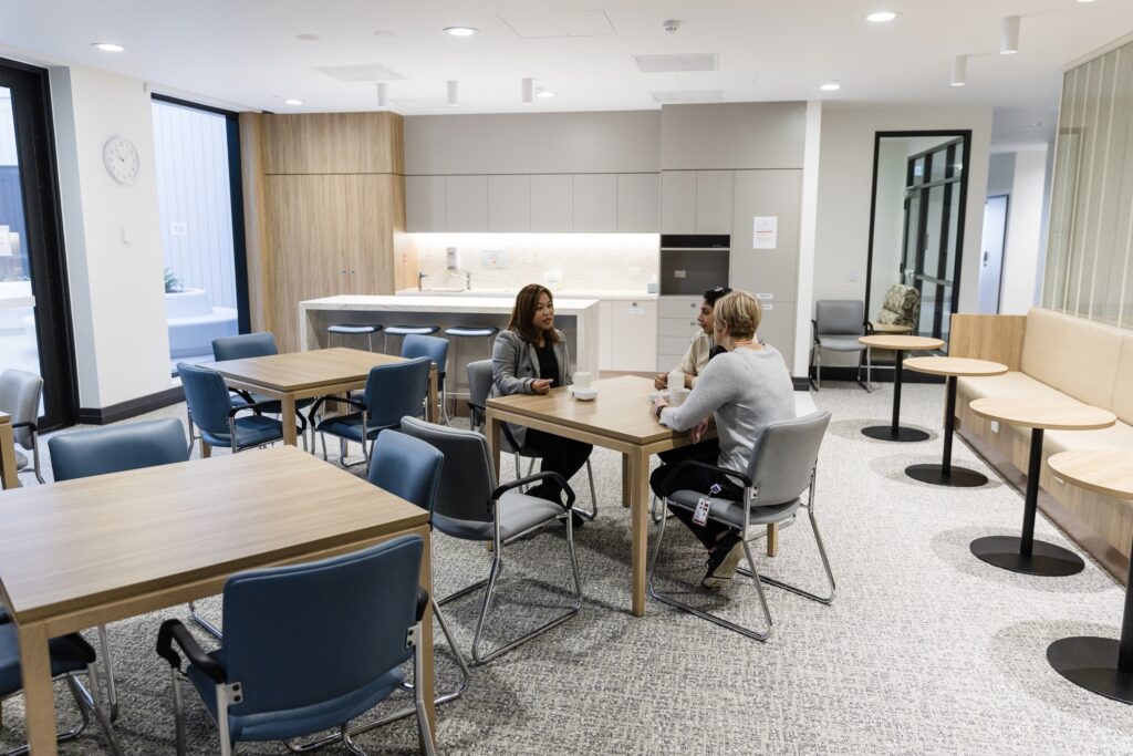 Patients having coffee in the open plan dining area of the mental health unit.