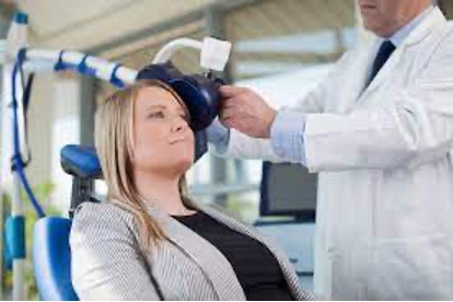 A picture of a woman undergoing transcranial magnetic stimulation for the treatment of depression.